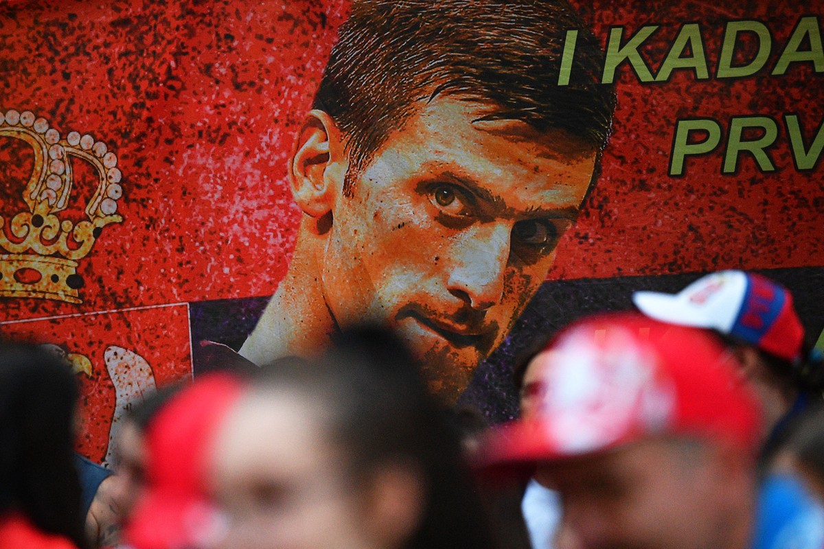 epa09677121 Members of the Serbian community march in Melbourne, Australia, 10 January 2022. Serbian tennis player Novak Djokovic was to be released from an immigration detention center in Melbourne a ...
