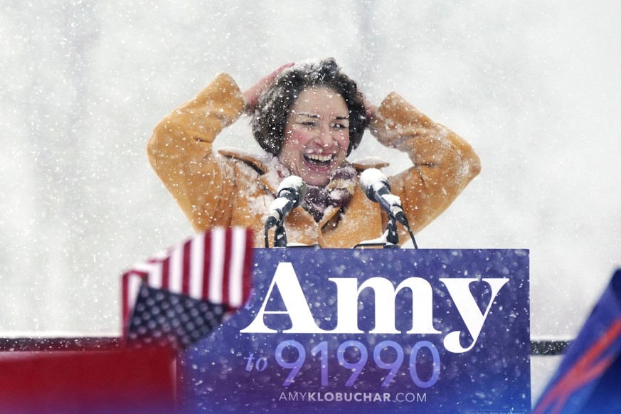 U.S. Sen. Amy Klobuchar wipes snow from her hair after announcing she is running for president of the United States, at Boom Island Park, Sunday, Feb. 10, 2019, in Minneapolis. Klobuchar joined the gr ...