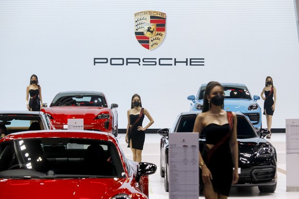 epa09843792 Models perform at the Porsche stand at the 43rd Bangkok International Motor Show 2022 in Bangkok, Thailand, 23 March 2022. The show is Thailand?s largest auto show, and runs from 23 March  ...