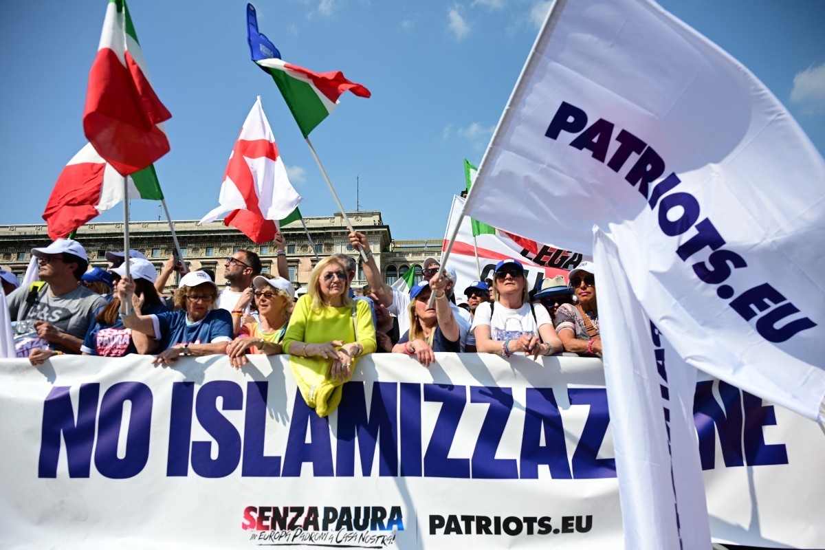 People gather at Piazza Duomo during a rally organized by the Patriots for Europe group (PfE) at the European Parliament and titled