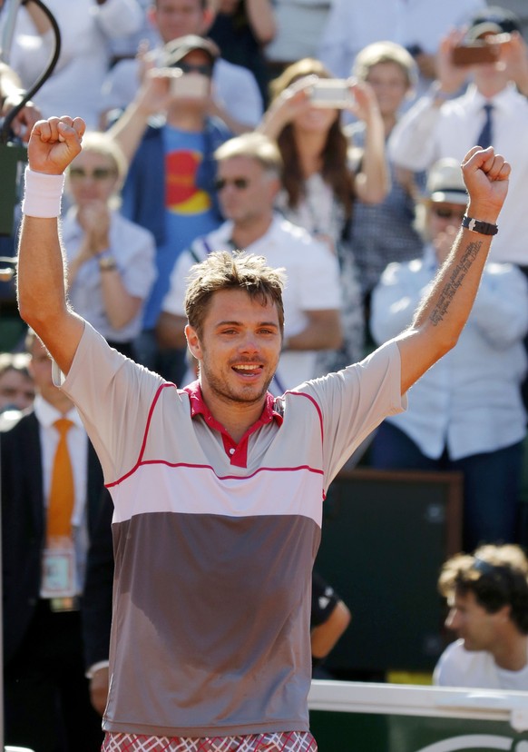 Stan Wawrinka of Switzerland celebrates after winning his men&#039;s singles final match against Novak Djokovic of Serbia during the French Open tennis tournament at the Roland Garros stadium in Paris ...