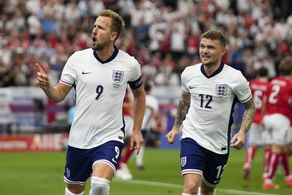 England&#039;s Harry Kane (9) celebrates with Kieran Trippier (12) after scoring a goal during a Group C match between Denmark and England at the Euro 2024 soccer tournament in Frankfurt, Germany, Thu ...