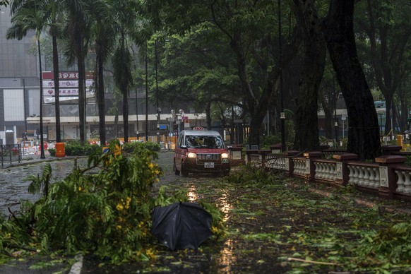 A taxi drives near fallen trees following the Typhoon Wipha, in Hong Kong, Sunday, July 20, 2025. (AP Photo/Vernon Yuen)
Hong Kong Asia Storm