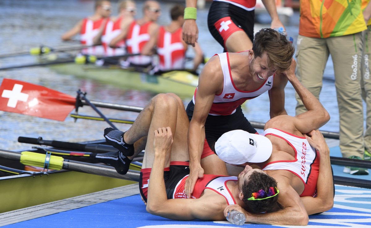 From left, Lucas Tramer, Simon Schuerch, Mario Gyr and Simon Niepmann, behind, of Switzerland react after winning the gold medal of the men's Lightweight Four final at the Lagoa Stadium in Rio de ...