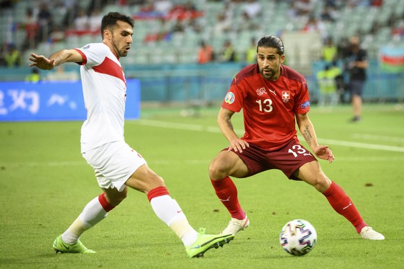 epa09288980 Turkey&#039;s defender Zeki Celik (L) in action against Switzerland&#039;s defender Ricardo Rodriguez during the UEFA EURO 2020 group A preliminary round soccer match between Switzerland a ...