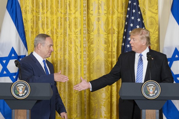 epa05795541 US President Donald J. Trump (R) shakes hands with Israeli Prime Minister Benjamin Netanyahu (L) during a joint press conference in the East Room in of the White House in Washington, DC, U ...