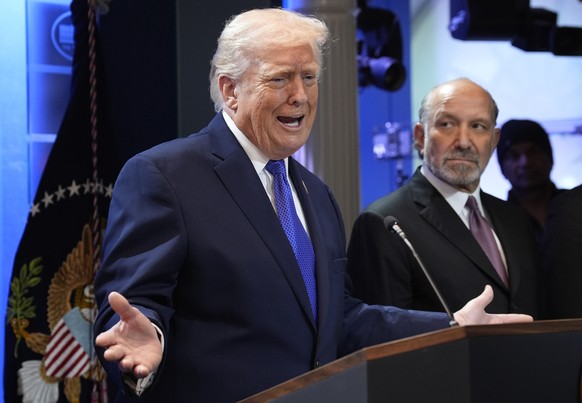 epa12763409 US President Donald J. Trump, alongside Commerce Secretary Howard Lutnick (R), speaks about the Supreme Court's striking down of most of his tariffs during a press conference in the b ...