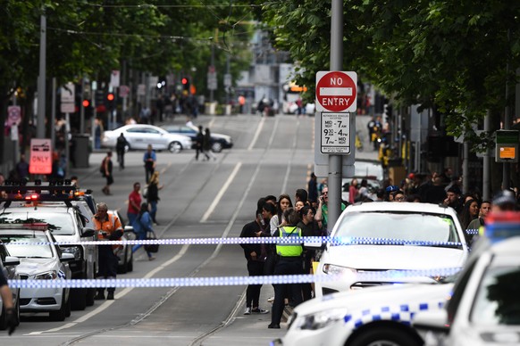 epa07152769 Members of the emergency services on Swanston street in Melbourne, Australia, 09 November 2018. According to early media reports, an unidentified man set a vehicle alight and stabbed two p ...