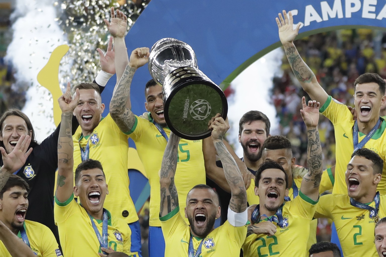 Brazil's Dani Alves lifts up his team's trophy after winning the final soccer match of the Copa America against Peru at Maracana stadium in Rio de Janeiro, Brazil, Sunday, July 7, 2019. Brazil won 3-1 ...