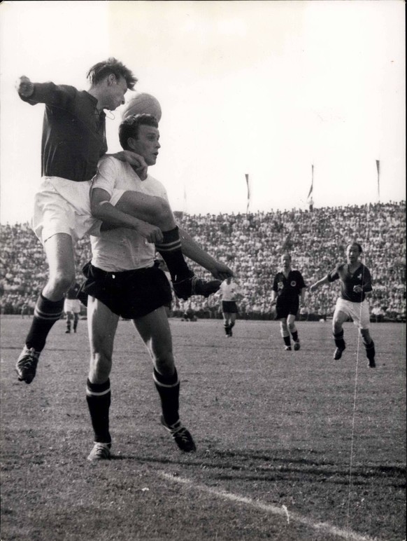 Jun. 26, 1954 - Swiss - Austria in Lausanne 5 : 7: A double foul , as picture shows. The swiss forward Charles Antenen is holding his opponent while the other is keeping his leg tight. The arbitrator ...