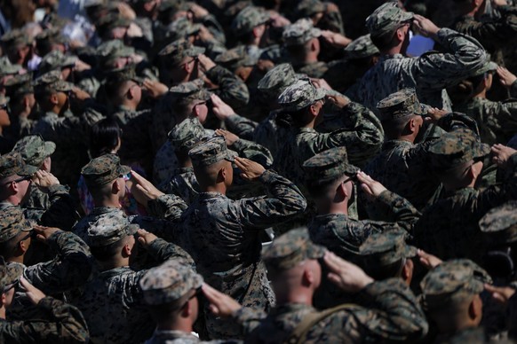 epa12463604 US Marines salute during the &#039;America&#039;s Marines 250: From Sea to Shore-A Review of Amphibious Strength&#039; event, part of the celebrations marking the U.S. Marine Corps 250th a ...
