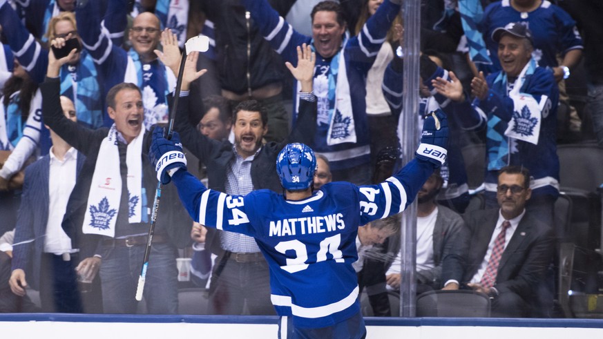 Toronto Maple Leafs center Auston Matthews (34) celebrates his game-winning goal with fans during during overtime against the Montreal Canadiens in an NHL hockey game Wednesday, Oct. 3, 2018, in Toron ...