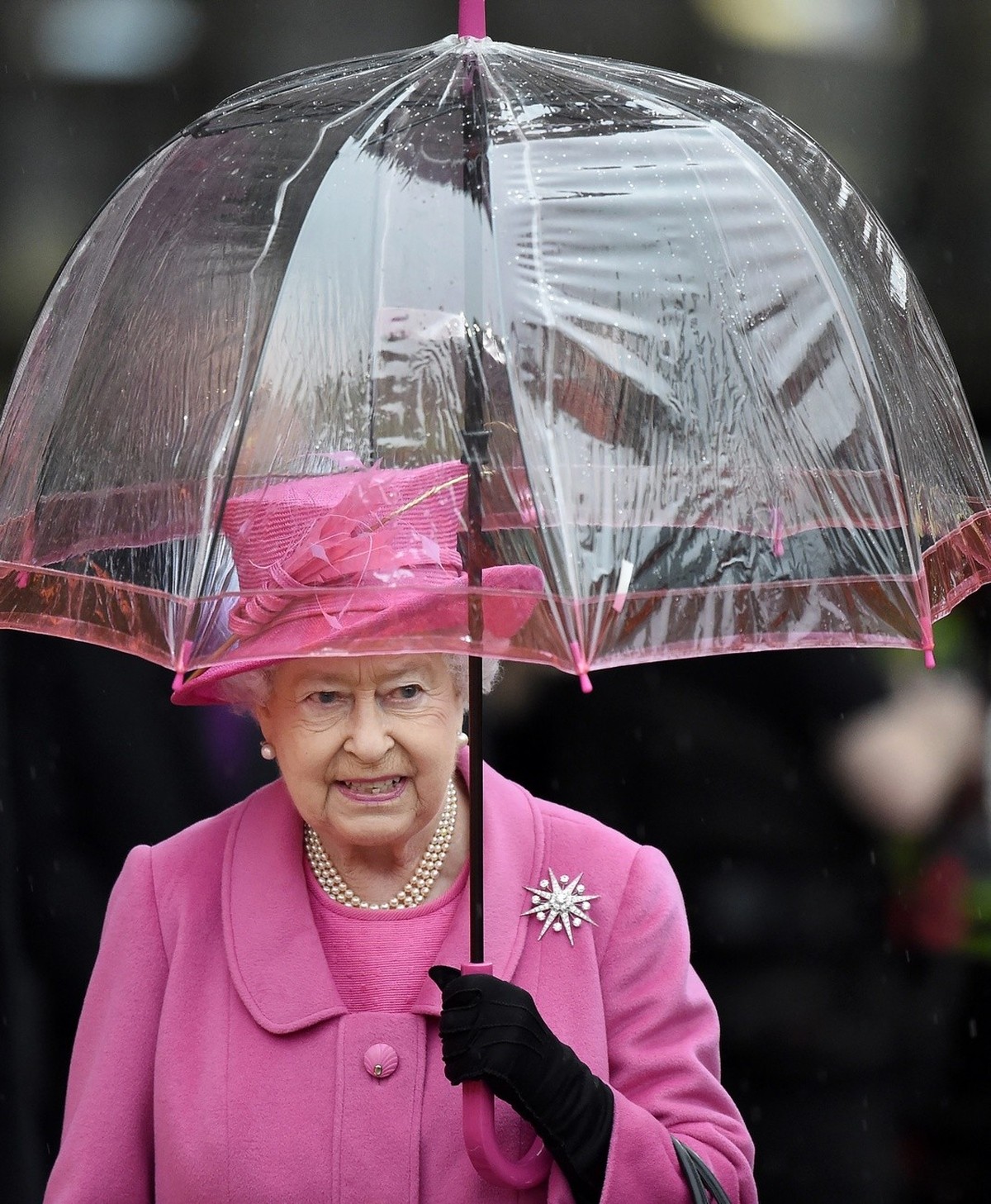 Britain's Queen Elizabeth II holds an umbrella during her visit to Birmingham New Street Station which has recently reopened after a 750m GBP refurbishment, in Birmingham, Britain, 19 November 20 ...