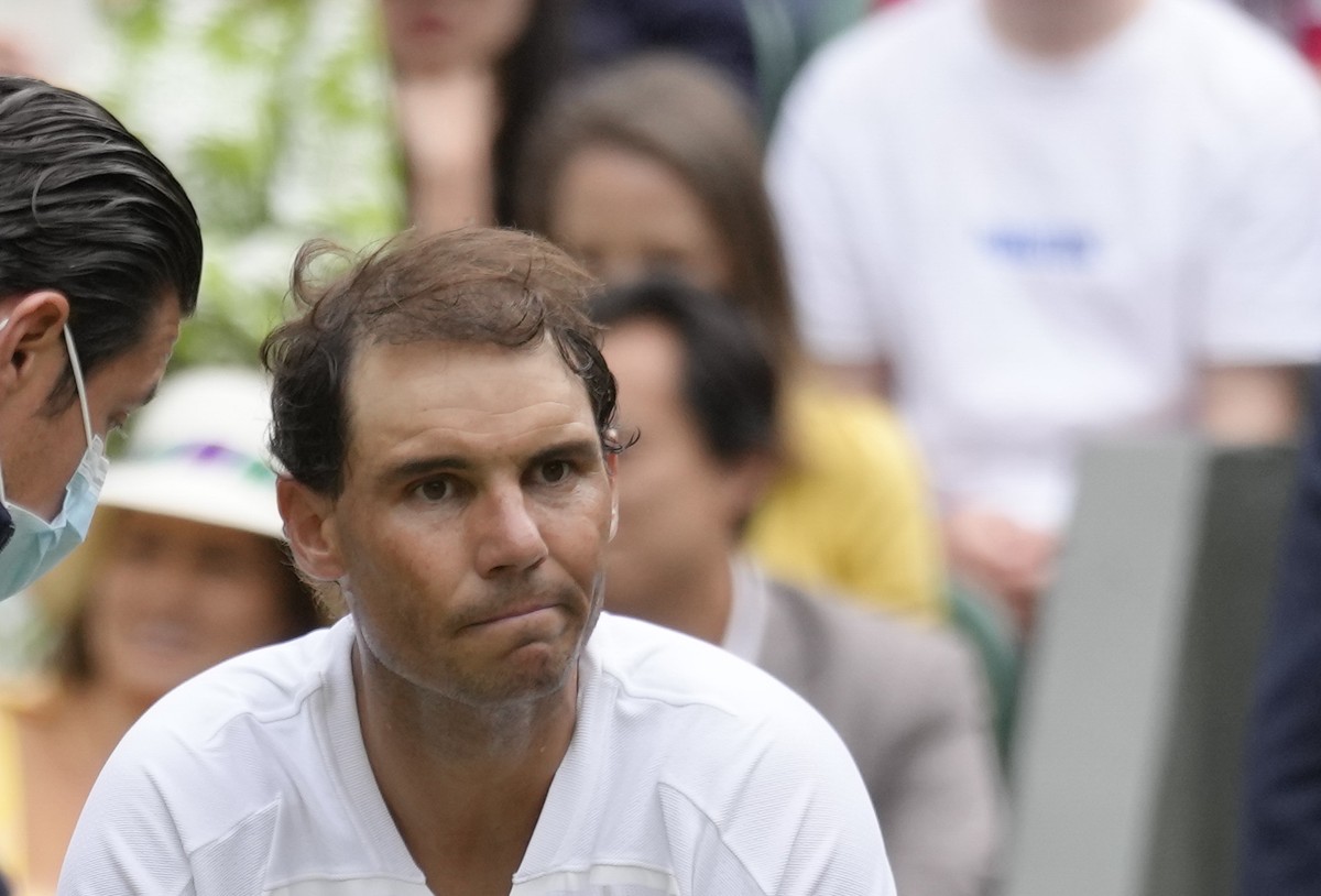 FILE - Spain's Rafael Nadal receives treatment just before a medical timeout as he plays Taylor Fritz of the US in a men's singles quarterfinal match on day ten of the Wimbledon tennis champ ...
