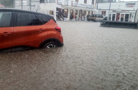 epa06771370 A car stands on a flooded road in Wuppertal, Germany, 29 May 2018. The German Meteorological Service (DWD) has issued severe weather warnings due to strong winds and heavy rain. EPA/STRING ...