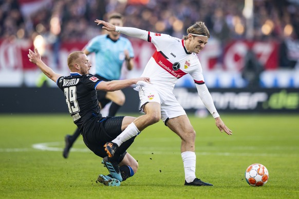 Stuttgart's Borna Sosa in action against Bielefeld's Sebastian Vasiliadis, left, during a German Bundesliga match between VfB Stuttgart and Arminia Bielefeld in Stuttgart, Germany, Saturday, Nov.6, 2021. (Tom Weller/dpa via AP)