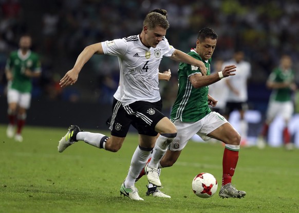 Mexico&#039;s Javier Hernandez, right, fights for the ball with Germany&#039;s Matthias Ginter during the Confederations Cup, semifinal soccer match between Germany and Mexico, at the Fisht Stadium in ...