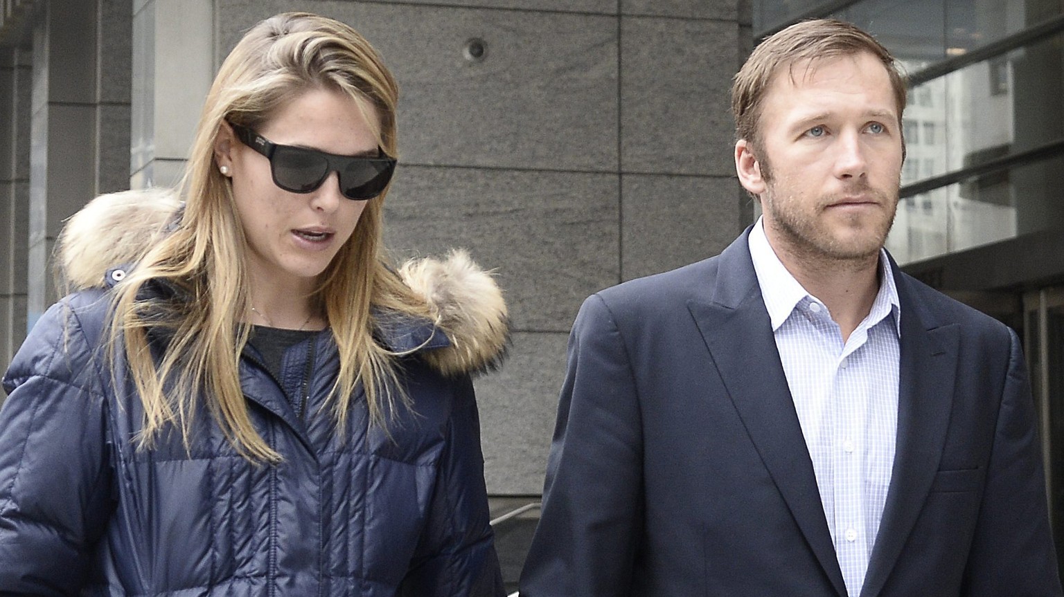epa04158041 US skier Bode Miller (R) and wife Morgan Beck Miller (L) leave a family court in New York, New York, USA, 07 April 2014. Miller was at court due to a dispute with his ex-girlfriend Sara Mc ...