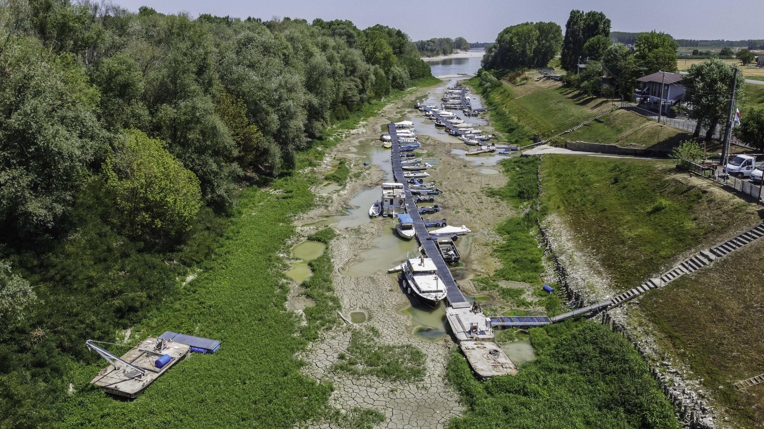 epa10075765 A photo taken with a drone shows the dry bed of the Po River between Parma and Reggio Emilia, Italy, 17 July 2022. Northern Italy has been struggling with a drought that began in winter, f ...