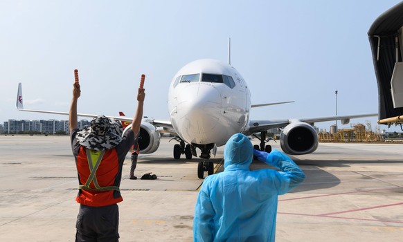 200408 -- SANYA, April 8, 2020 -- Flight MU2527 of China Eastern airlines glides to the appointed location in the guidance of staff members at the Phoenix International Airport in Sanya, south China s ...