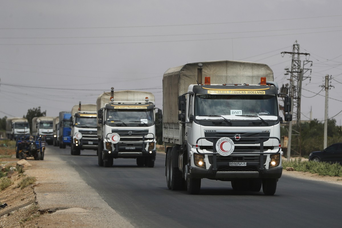 A convoy of vehicles loaded with food and other aid is en route to Sweida on the international highway in rural Daraa province, Syria, Sunday, July 20, 2025, heading to the city of Busra al-Sham. (AP  ...