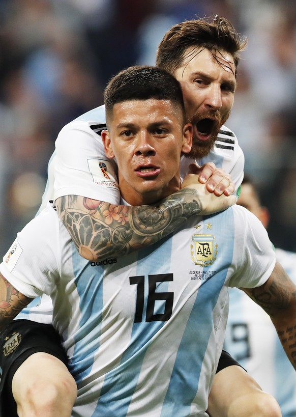 epa06842853 Marcos Rojo of Argentina celebrates with teammate Lionel Messi (top) after scoring the 2-1 during the FIFA World Cup 2018 group D preliminary round soccer match between Nigeria and Argenti ...