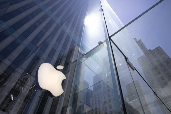 FILE - In this June 16, 2020 file photo, the sun is reflected on Apple&#039;s Fifth Avenue store in New York. Apple will reports earnings on Thursday May 2, 2024. (AP Photo/Mark Lennihan, File)