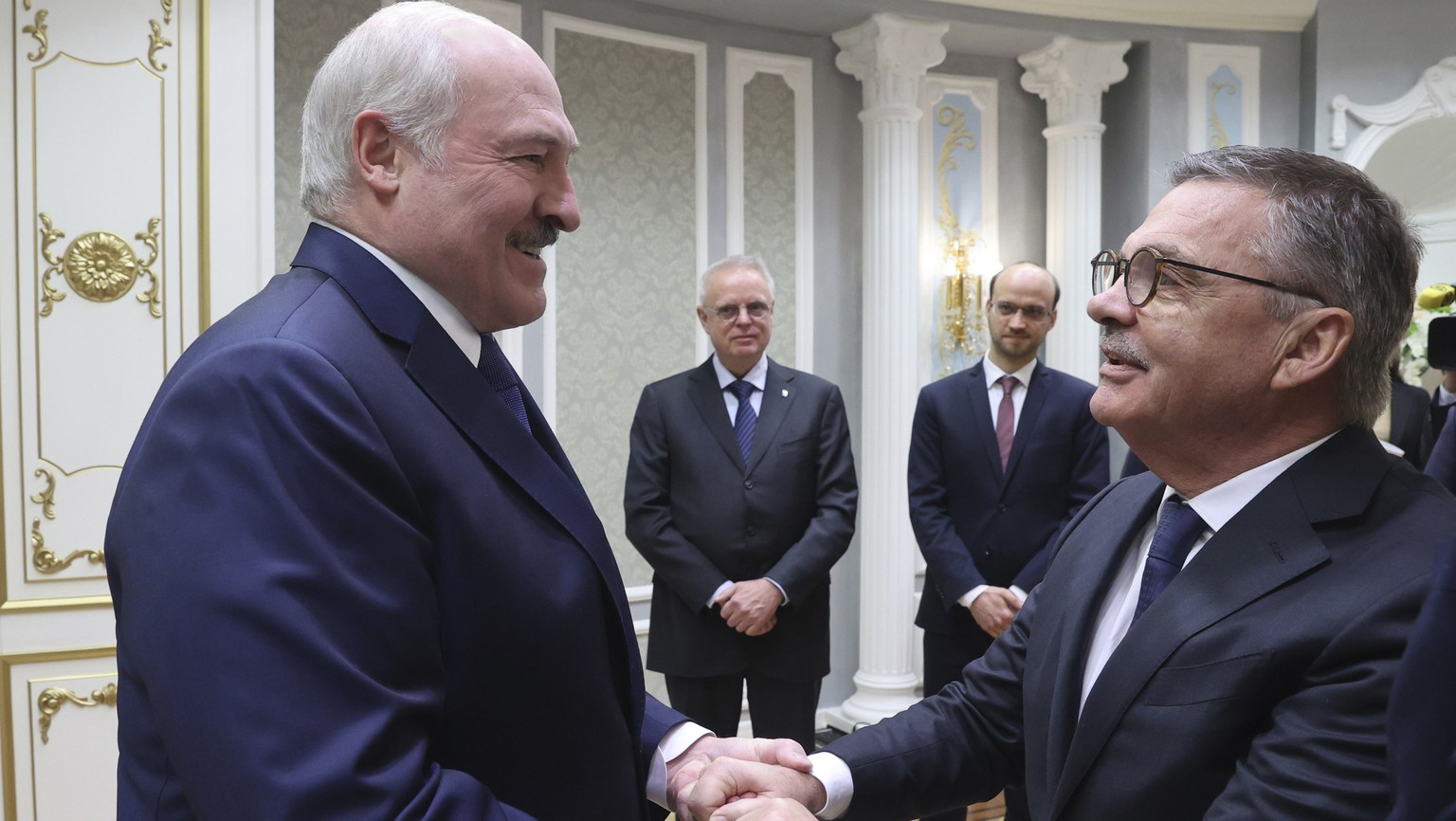 Belarusian President Alexander Lukashenko, left, greets International Ice Hockey Federation President Rene Fasel during their meeting in Minsk, Belarus, Monday, Jan. 11, 2021. (Nikolai Petrov/BelTA Po ...