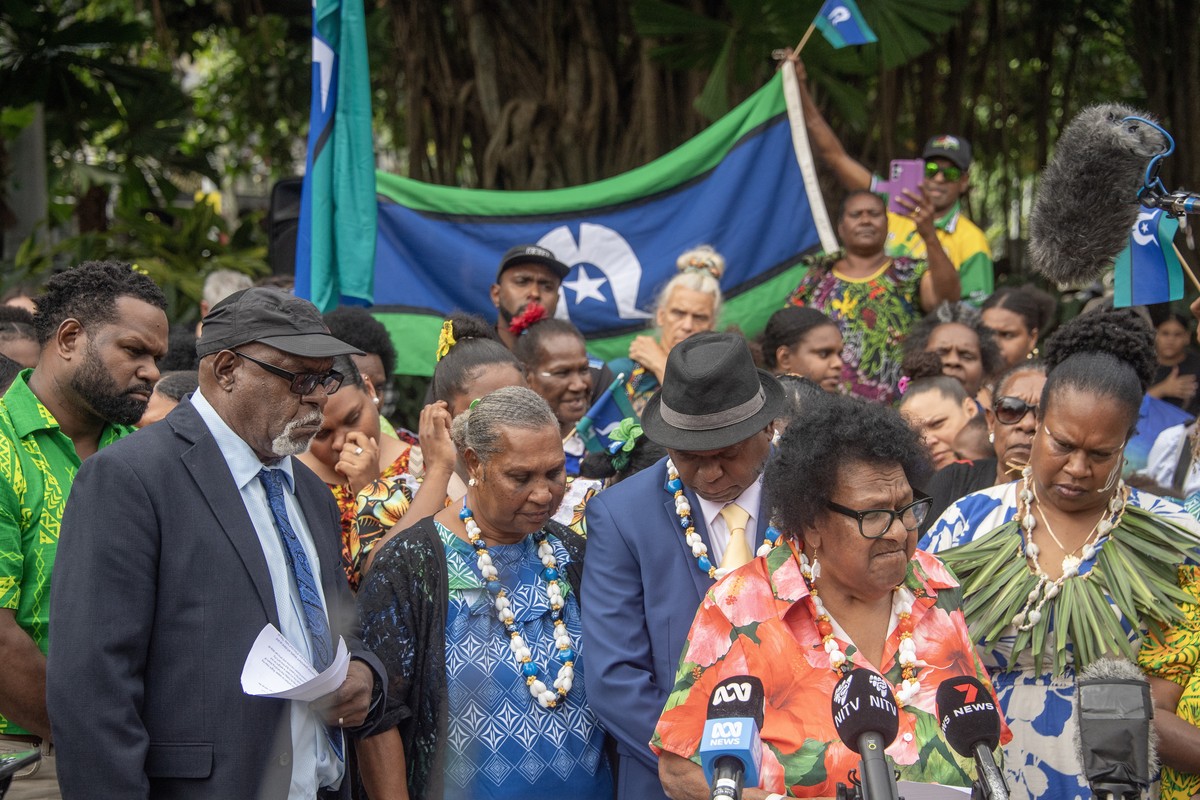 epa12238642 Aunty McRose Elu (C) adresses the crowd with Uncle Pabai Pabai behind her and Uncle Paul Kabia (L) after the Federal Court of Australia decision in Cairns, Australia, 15 July 2025. The Fed ...
