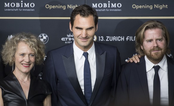 Swiss tennis player Roger Federer, center, poses next to Corine Mauch, mayor of Zuerich, left, and Danish filmmaker Janus Metz Pedersen, right, of on the Green Carpet for the Opening Night of the 13th ...