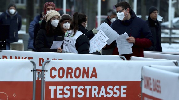 People line up a corona test street for a mass Covid-19 testing in Vienna, Austria, Friday, Dec 4, 2020. Written on the poster &quot; corona test street&quot;. Austria conducts a mass Covid-19 testing ...