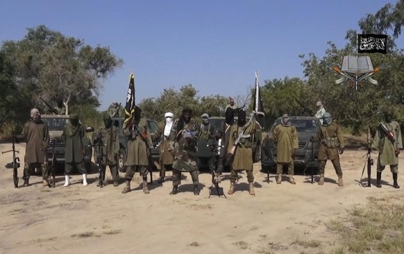 FILE - In his file image taken from video released late Friday evening, Oct. 31, 2014, by Boko Haram, Abubakar Shekau, centre, the leader of Nigeria&#039;s Islamic extremist speaks in an unidentified  ...