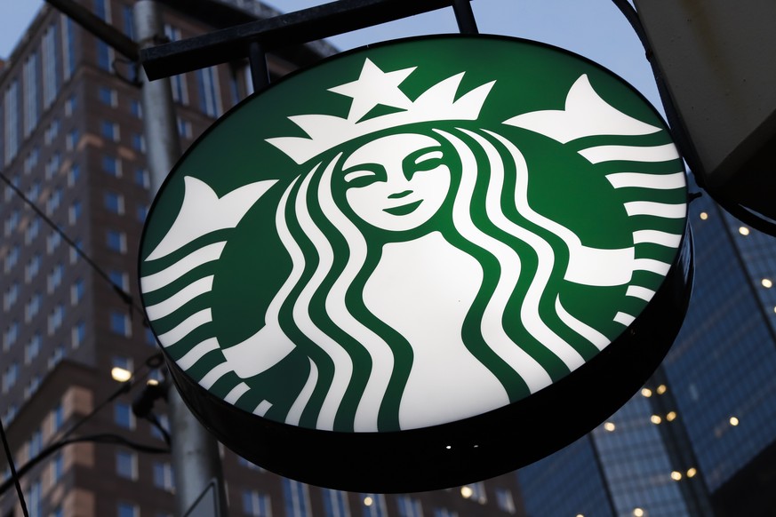 FILE - This June 26, 2019, file photo shows a Starbucks sign outside a Starbucks coffee shop in downtown Pittsburgh. The coffee chain will quit selling The New York Times, Wall Street Journal or Ganne ...