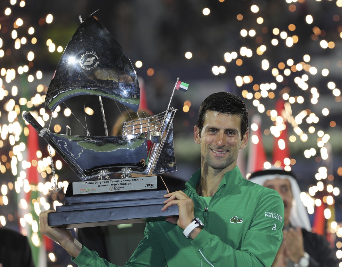 Serbia's Novak Djokovic holds the trophy after he beats Stefanos Tsitsipas of Greece in the final match of the Dubai Duty Free Tennis Championship in Dubai, United Arab Emirates, Saturday, Feb. 2 ...