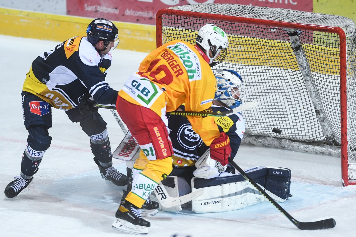 Tiger's player Pascal Gerber, center, scores the 0-1 goal against Ambri's goalkeeper Damiano Ciaccio, during the match of National League A (NLA) Swiss Championship 2020/21 between HC Ambri  ...