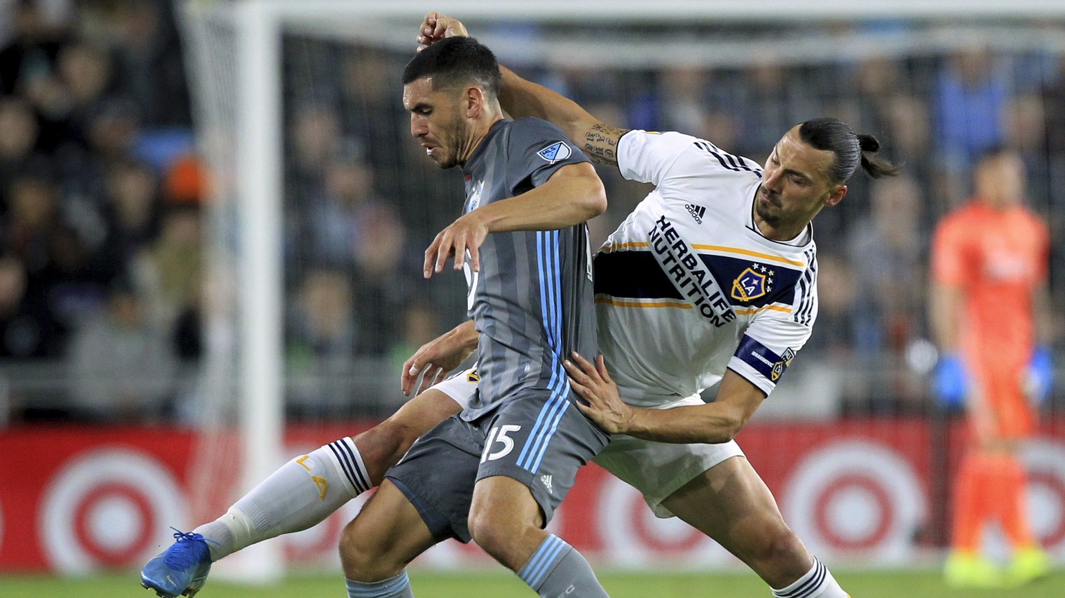 LA Galaxy midfielder Zlatan Ibrahimovic (9) battles for the ball with Minnesota United defender Michael Boxall (15) during the first half of an MLS soccer first-round playoff match, Sunday, Oct. 20, 2 ...