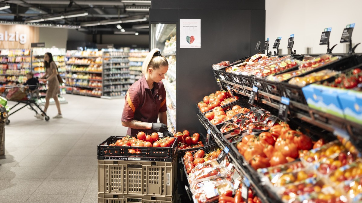 Eine Angestellte von Migros raeumt am Morgen die Fruechte und das Gemuese in die Regale, fotografiert am Mittwoch 23. Juli 2025 im Appenzell. (KEYSTONE/Gaetan Bally)