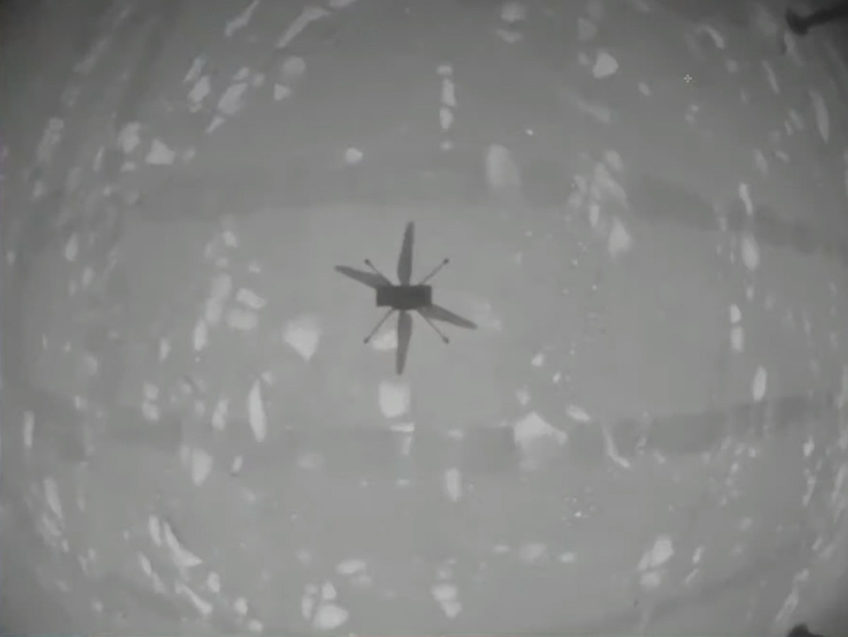 epa09144917 A handout video still taken from a livestream by NASA shows shadow of the Ingenuity Mars Helicopter during its first test flight on Mars, 19 April 2021. According to NASA, Ingenuity has su ...