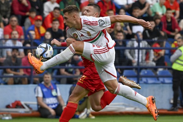 epa10697090 Willi Orban (front) of Hungary in action against Milutin Osmajic of Montenegro during the UEFA EURO 2024 qualifier soccer match between Montenegro and Hungary, in Podgorica, Montenegro, 17 ...