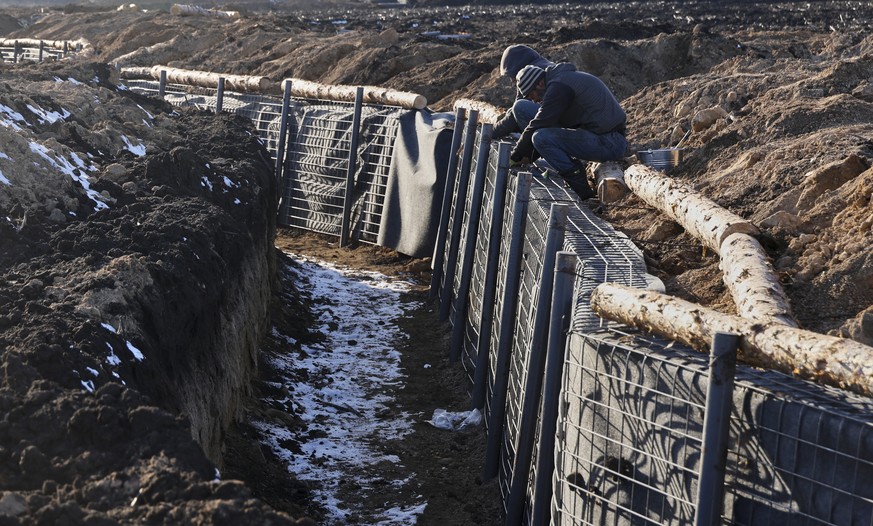 epa11216940 Workers build a fortification line at an undisclosed location in the Kharkiv region, Ukraine, 12 March 2024, amid the Russian invasion. Ukraine began to build huge defence lines protecting ...