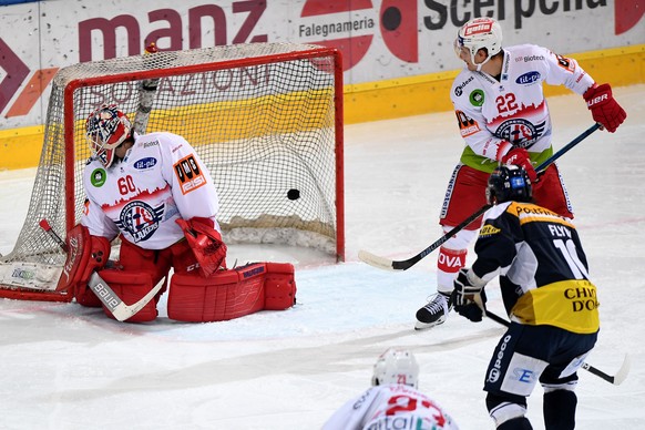 From left: Rapperswil&#039;s goalkeeper Melvin Nyffeler, Ambri&#039;s player Bryan Flynn and Rapperswil&#039;s player Cedric Haechler for the 1 - 0 goal, during the preliminary round game of National  ...