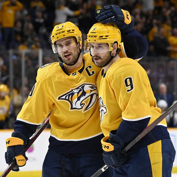 Nashville Predators left wing Filip Forsberg (9) celebrates with defenseman Roman Josi (59) after Forsberg scored a goal against the Vancouver Canucks during the second period of an NHL hockey game Tu ...