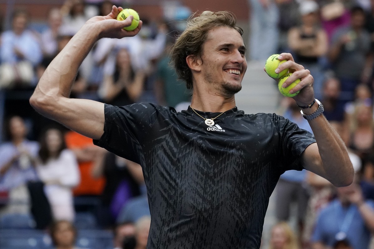 Alexander Zverev, of Germany, throws game balls to the crowd after defeating Lloyd Harris, of South Africa, during the quarterfinals of the US Open tennis championships, Wednesday, Sept. 8, 2021, in N ...