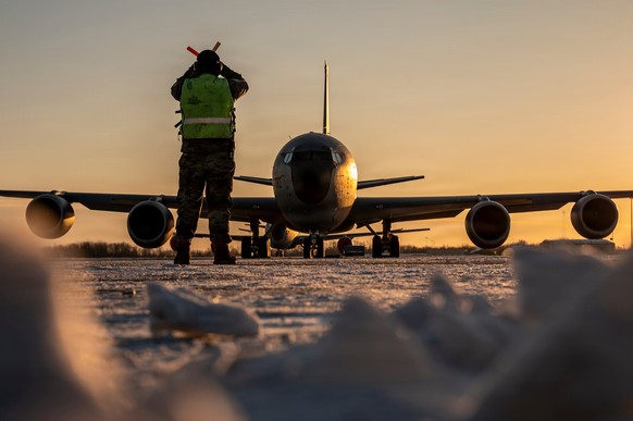 In this Jan. 28, 2026 photo, U.S. Air Force Master Sgt. Aaron Slupski, a crew chief with the 121st Maintenance Group, prepares to marshal a KC-135 Stratotanker at Rickenbacker Air National Guard Base, ...
