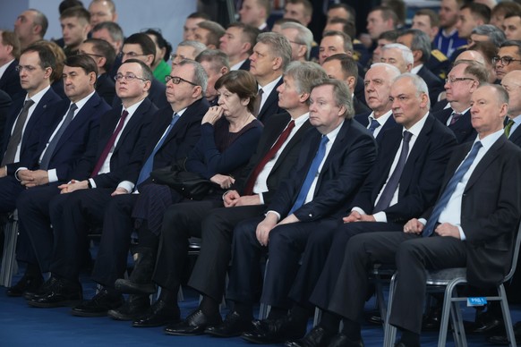 Participants listen to Russian President Vladimir Putin's annual state of the nation address in Moscow, Russia, Tuesday, Feb. 21, 2023. (Mikhail Metzel, Sputnik, Kremlin Pool Photo via AP)