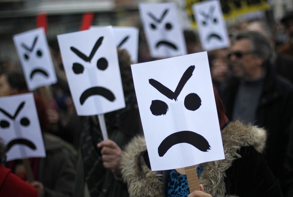 Demonstrators holding placards march down Lisbon&#039;s main Liberdade avenue during a protest against austerity measures taken by the Portuguese government in exchange of a euro 78 billion ($101 bill ...