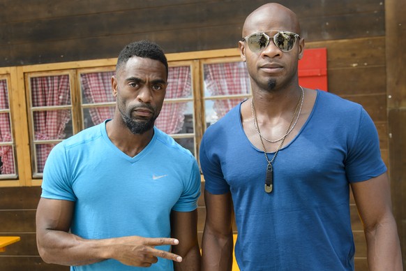 Tyson Gay, from the USA, left, and Asafa Powell, from Jamaica, right, during a press conference on the eve of the Athletissima international Athletics meeting, in Lausanne, Switzerland, Wednesday, Jul ...