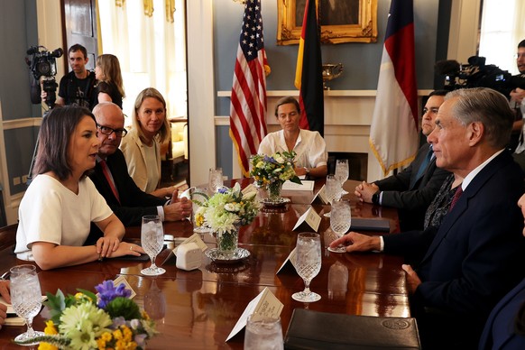 epa10857488 German Foreign Minister Annalena Baerbock (L) talks with Texas Governor Greg Abbott (R) at the Governor's House in Austin, Texas, USA, September 12, 2023. This is the…