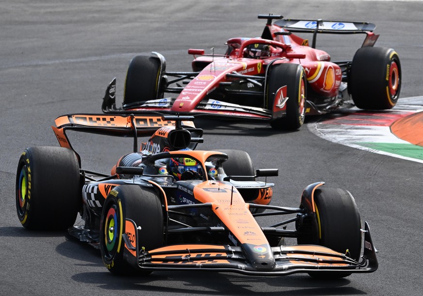 epa11577645 McLaren driver Oscar Piastri of Australia steers his car ahead of Scuderia Ferrari driver Charles Leclerc of Monaco during of the Formula One Grand Prix of Italy, in Monza, Italy, 01 Septe ...