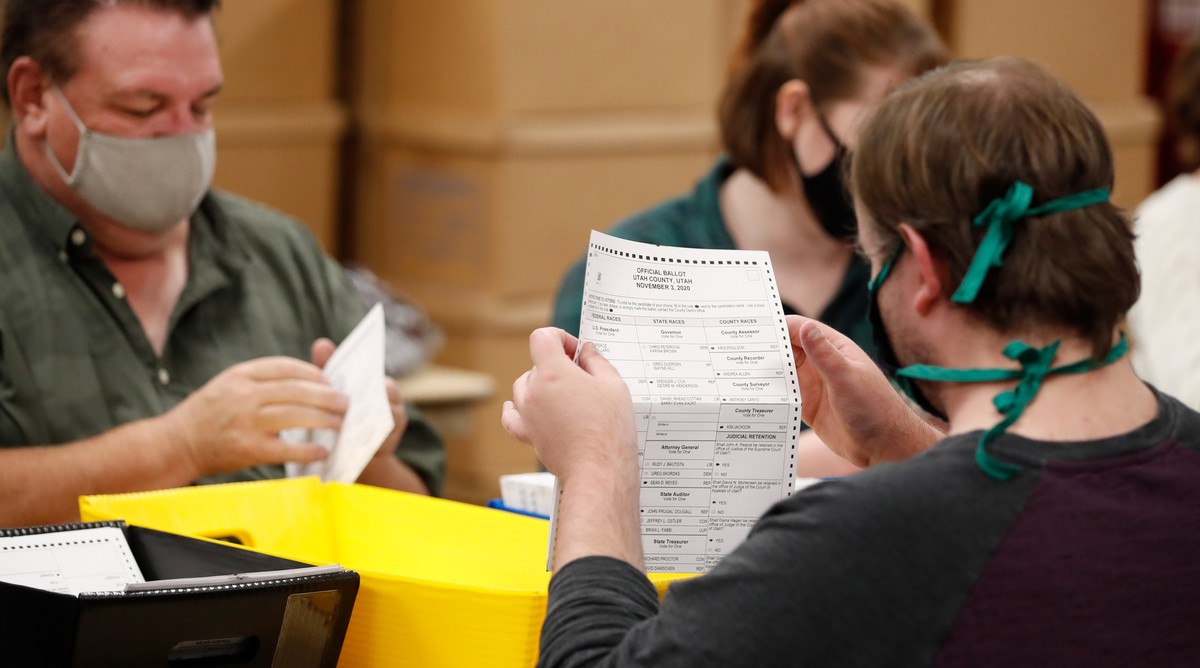 epa08794003 Election workers looks over a ballot for errors at the Utah County Election offices in Provo, Utah, USA, 02 November 2020. Utah is one of many states the US that have gone to a mail in bal ...